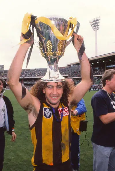 MELBOURNE, AUSTRALIA - SEPTEMBER 25: John Platten of the Hawks celebrates with the trophy after winning the 1988 VFL Grand Final match between Hawthorn Hawks and Melbourne Demons at the Melbourne Cricket Ground on September 25, 1988 in Melbourne, Australia. (Photo by Getty Images)