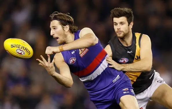 MELBOURNE, AUSTRALIA - JULY 09: Marcus Bontempelli of the Bulldogs is tackled by Trent Cotchin of the Tigers during the 2016 AFL Round 16 match between the Western Bulldogs and the Richmond Tigers at Etihad Stadium on July 9, 2016 in Melbourne, Australia. (Photo by Michael Willson/AFL Media/Getty Images)