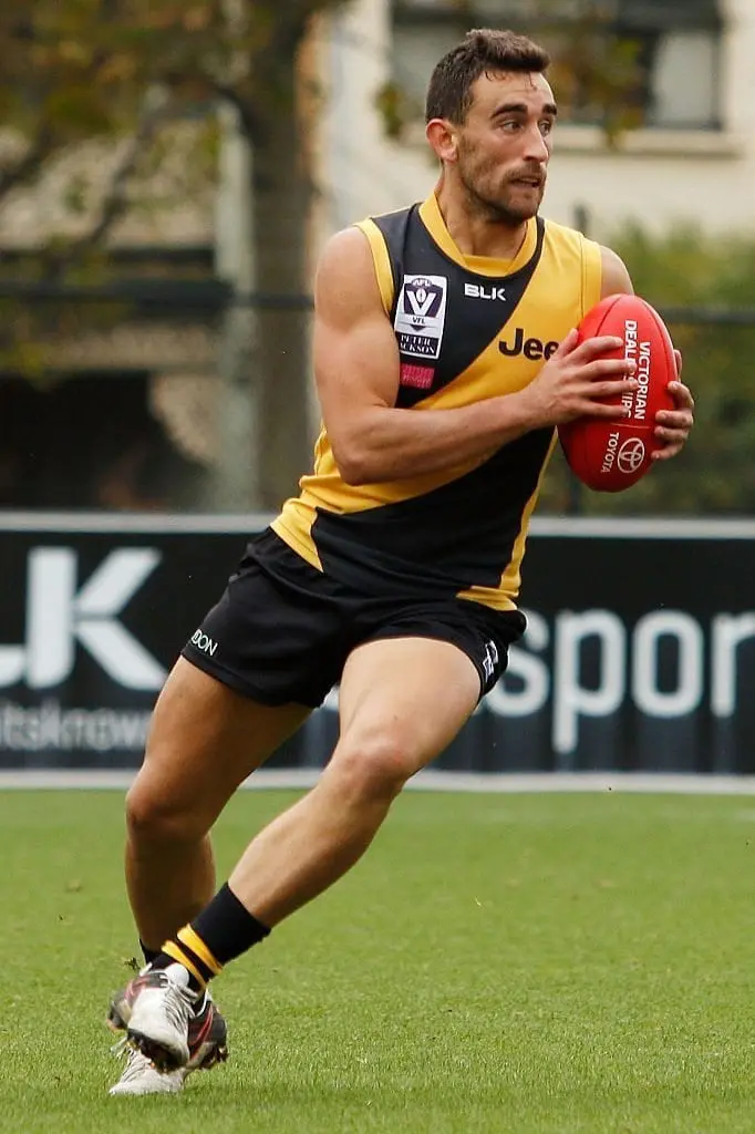 MELBOURNE, AUSTRALIA - APRIL 16: Adam Marcon of Richmond runs with the ball during the round two VFL match between the Richmond Tigers and the Footscray Bulldogs at Punt Road Oval on April 16, 2016 in Melbourne, Australia. (Photo by Jack Thomas/AFL Media/Getty Images)