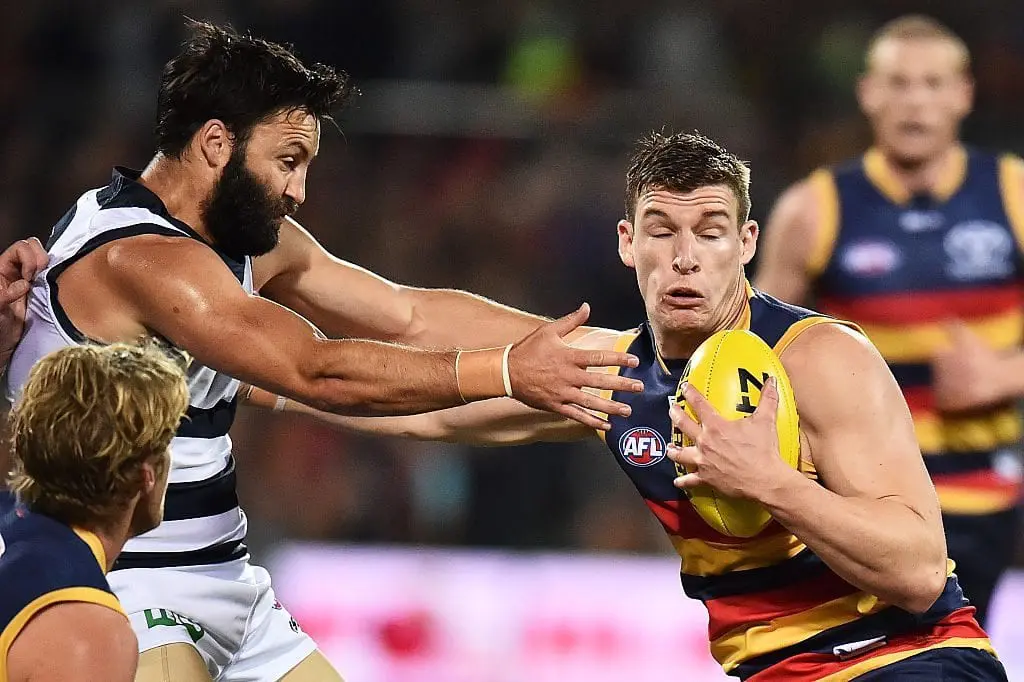 ADELAIDE, AUSTRALIA - MAY 13: (L-R) Jimmy Bartel of the Cats attempts to tackle Josh Jenkins of the Crows during the round eight AFL match between the Adelaide Crows and the Geelong Cats at Adelaide Oval on May 13, 2016 in Adelaide, Australia.  (Photo by Daniel Kalisz/Getty Images)