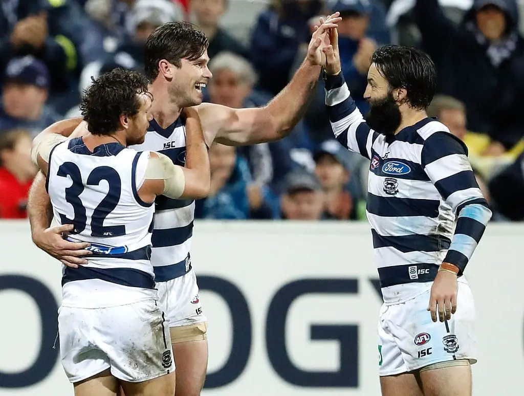 GEELONG, AUSTRALIA - JULY 23: Tom Hawkins of the Cats celebrates a goal with Steven Motlop (left) and Jimmy Bartelcof the Cats during the 2016 AFL Round 18 match between the Geelong Cats and the Adelaide Crows at Simonds Stadium on July 23, 2016 in Geelong, Australia. (Photo by Adam Trafford/AFL Media/Getty Images)
