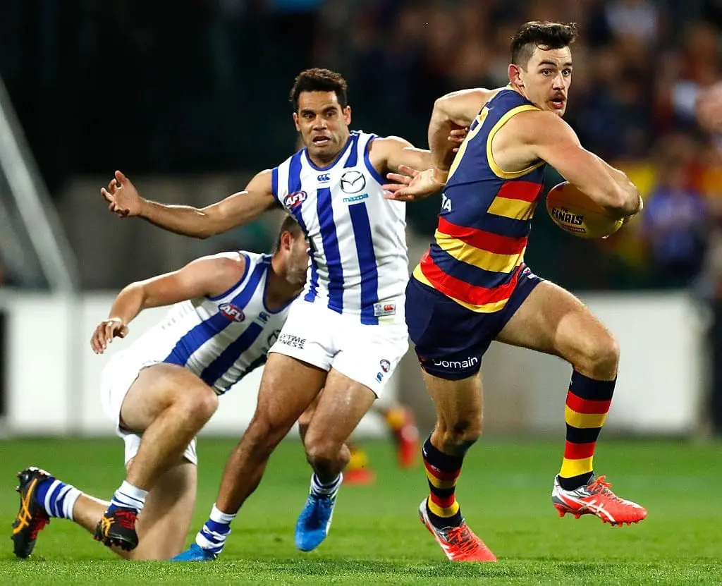 ADELAIDE, AUSTRALIA - SEPTEMBER 10: Taylor Walker of the Crows in action ahead of Daniel Wells of the Kangaroos during the 2016 AFL First Elimination Final match between the Adelaide Crows and the North Melbourne Kangaroos at the Adelaide Oval on September 10, 2016 in Adelaide, Australia. (Photo by Adam Trafford/AFL Media/Getty Images)