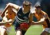AFL Pre-Season Fixture: Your team’s Community Series and match simulation opponents GEELONG, AUSTRALIA - FEBRUARY 17: Connor O'Sullivan of the Cats handballs whilst being tackled during the AFL practice match between Geelong Cats and Hawthorn Hawks at GMHBA Stadium on February 17, 2025 in Geelong, Australia. (Photo by Quinn Rooney/Getty Images)