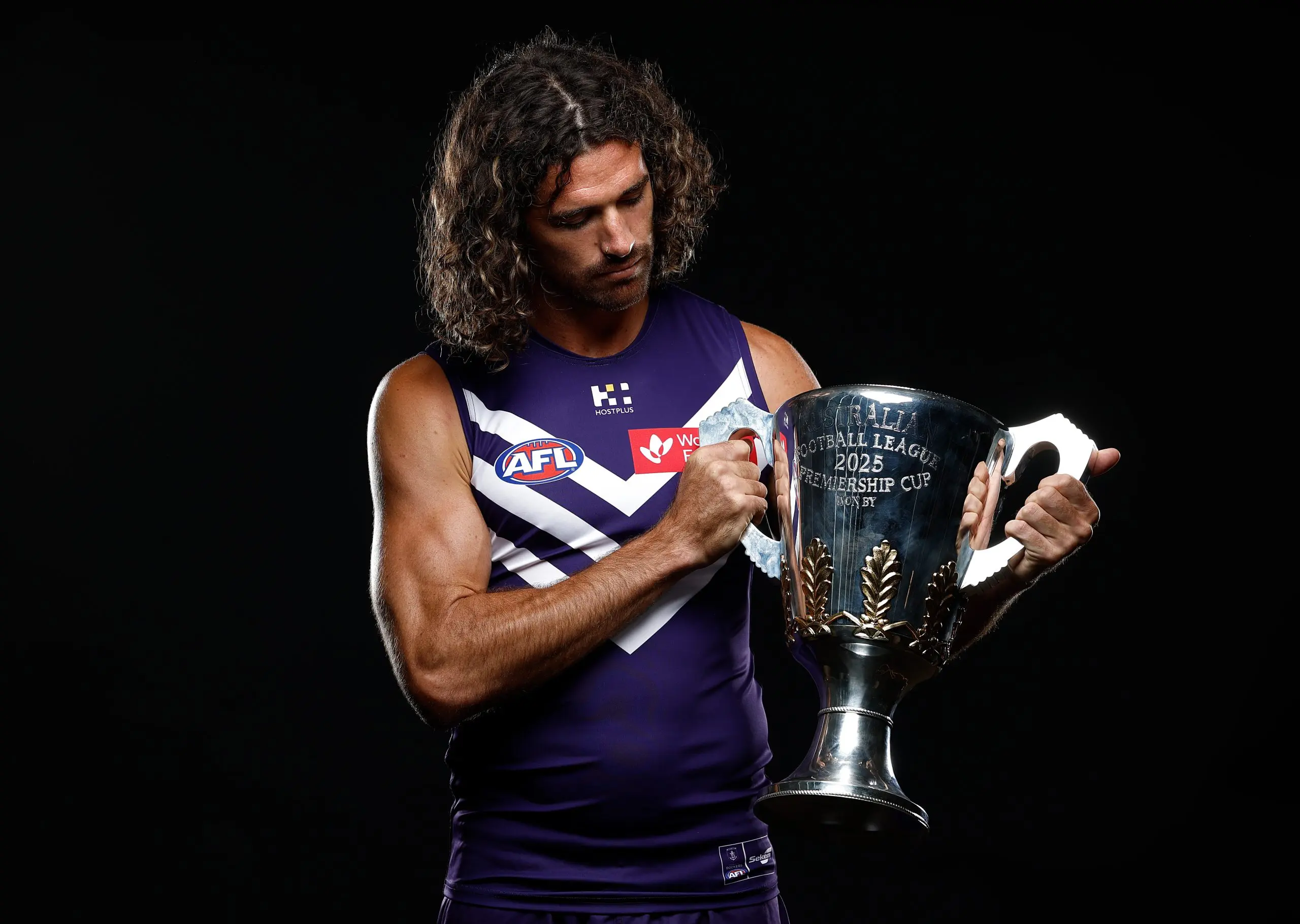 MELBOURNE, AUSTRALIA - FEBRUARY 24: Alex Pearce of the Dockers poses with the Premiership Cup during the 2025 AFL Captains Day at Marvel Stadium on February 24, 2025 in Melbourne, Australia. (Photo by Michael Willson/AFL Photos via Getty Images)