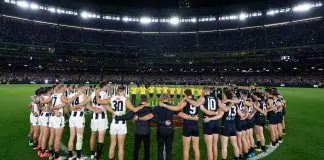 MELBOURNE, AUSTRALIA - MAY 03: Carlton and Collingwood players, coaches and umpires form a circle as a show of support against gender based violence before the 2024 AFL Round 08 match between the Carlton Blues and the Collingwood Magpies at The Melbourne Cricket Ground on May 03, 2024 in Melbourne, Australia. (Photo by Michael Willson/AFL Photos via Getty Images)