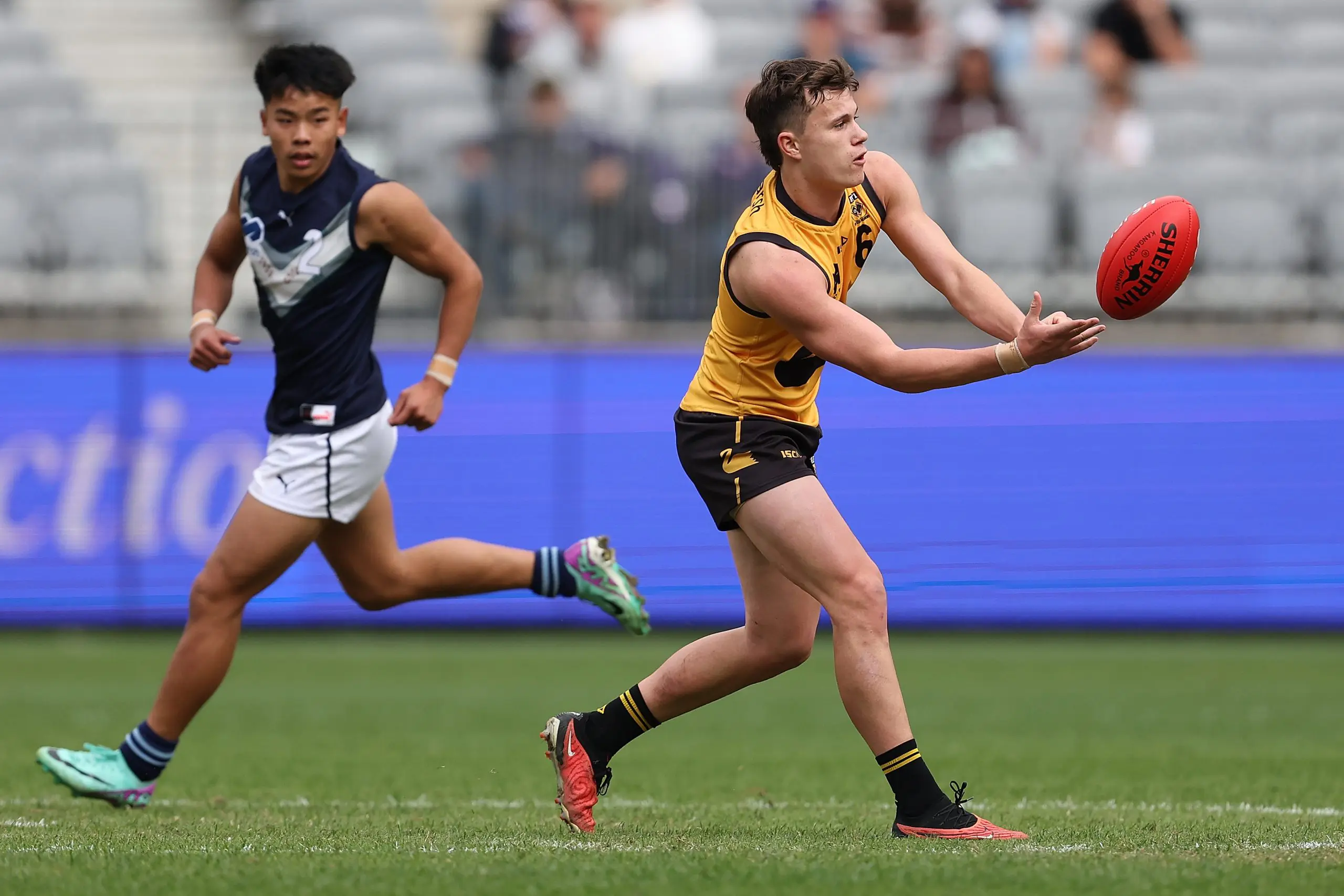 PERTH, AUSTRALIA - JUNE 23: Blake Kelly of Western Australia handballs during the Marsh AFL National Championships match between U18 Boys Western Australia and Victoria Metro at Optus Stadium on June 23, 2024 in Perth, Australia. (Photo by Paul Kane/AFL Photos/via Getty Images)