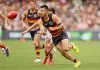 ADELAIDE, AUSTRALIA - MARCH 16: Alex Neal-Bullen of the Crows handpasses the ball during the 2025 AFL Round 01 match between the Adelaide Crows and the St Kilda Saints at Adelaide Oval on March 16, 2025 in Adelaide, Australia. (Photo by James Elsby/AFL Photos via Getty Images)