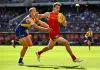PERTH, AUSTRALIA - MARCH 16: Charlie Ballard of the Suns chases the loose ball in front of Oscar Allen of the Eagles during the 2025 AFL Round 01 match between the West Coast Eagles and the Gold Coast Suns at Optus Stadium on March 16, 2025 in Perth, Australia. (Photo by Daniel Carson/AFL Photos via Getty Images)