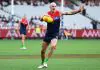 MELBOURNE, AUSTRALIA - MARCH 16: Aidan Johnson of the Demons kicks during the round one AFL match between Melbourne Demons and GWS Giants at Melbourne Cricket Ground, on March 16, 2025, in Melbourne, Australia. (Photo by Quinn Rooney/Getty Images)