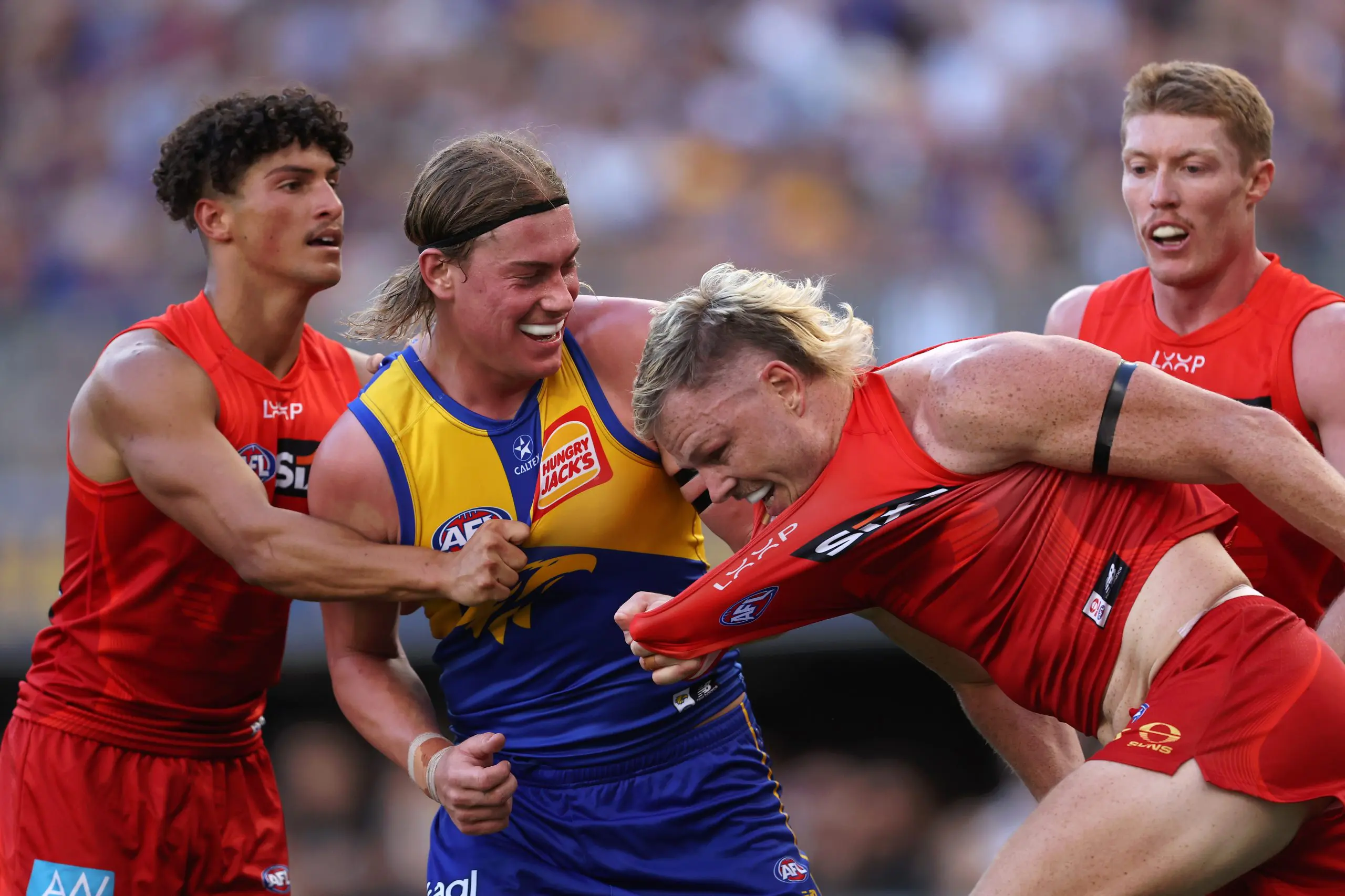 PERTH, AUSTRALIA - MARCH 16: Harley Reid of the Eagles wrestles with Nick Holman of the Suns during the round one AFL match between West Coast Eagles and Gold Coast Suns at Perth Stadium, on March 16, 2025, in Perth, Australia. (Photo by Paul Kane/Getty Images)
