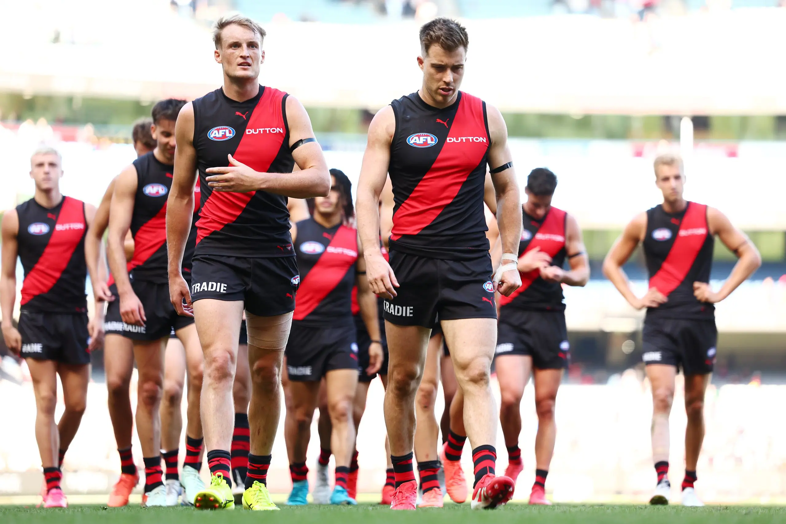 MELBOURNE, AUSTRALIA - MARCH 22: Mason Redman and Zach Merrett of the Bombers walk from the field following the round two AFL match between Essendon Bombers and Adelaide Crows at Melbourne Cricket Ground, on March 22, 2025, in Melbourne, Australia. (Photo by Morgan Hancock/AFL Photos/via Getty Images)