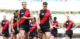 MELBOURNE, AUSTRALIA - MARCH 22: Mason Redman and Zach Merrett of the Bombers walk from the field following the round two AFL match between Essendon Bombers and Adelaide Crows at Melbourne Cricket Ground, on March 22, 2025, in Melbourne, Australia. (Photo by Morgan Hancock/AFL Photos/via Getty Images)