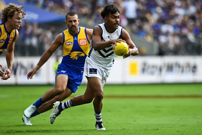 PERTH, AUSTRALIA - MARCH 30: Isaiah Dudley of the Dockers runs with the ball during the 2025 AFL Round 03 match between the West Coast Eagles and the Fremantle Dockers at Optus Stadium on March 30, 2025 in Perth, Australia. (Photo by Daniel Carson/AFL Photos via Getty Images)