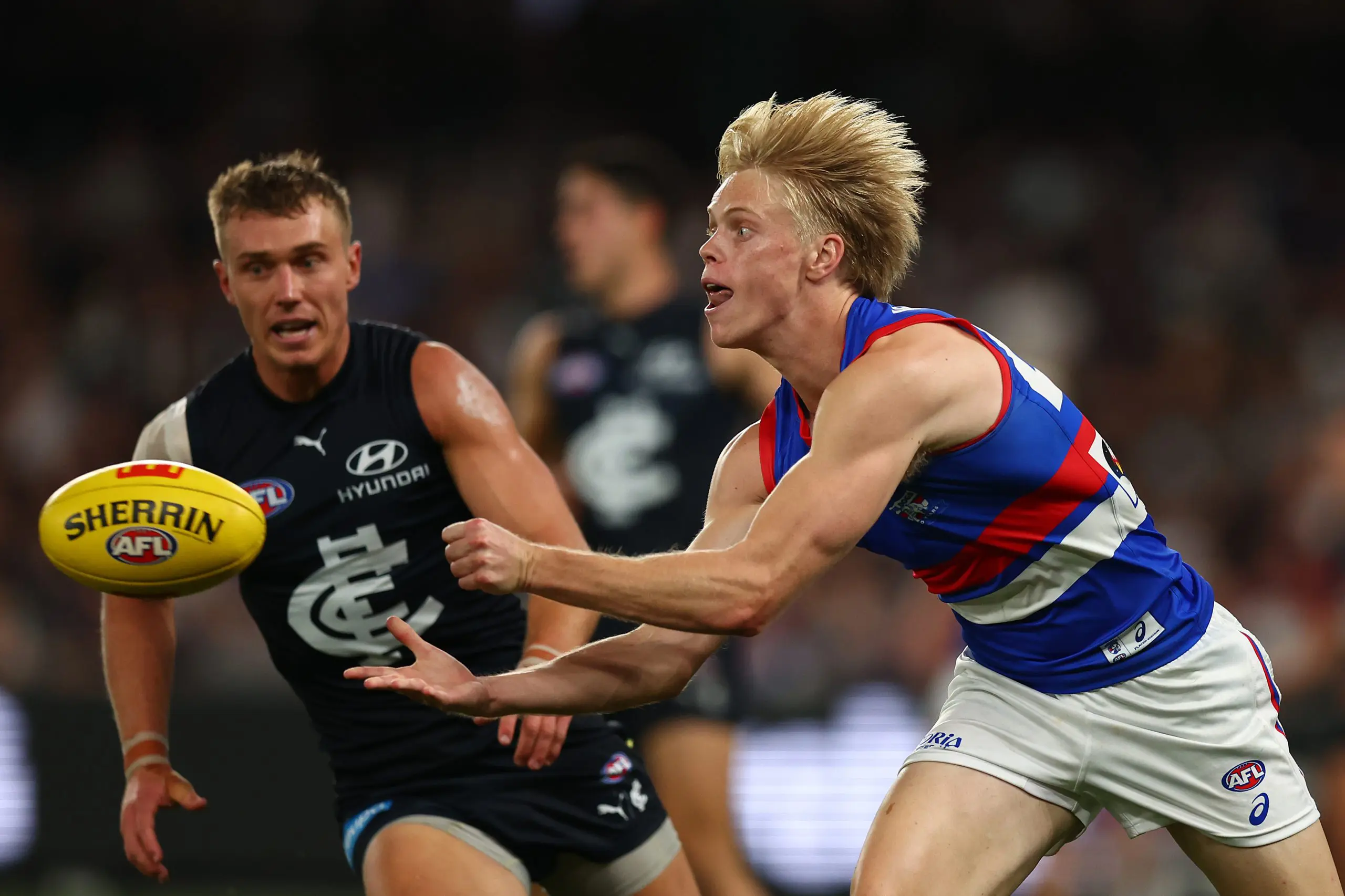 MELBOURNE, AUSTRALIA - MARCH 28: Sam Davidson of the Bulldogs handballs during the round three AFL match between Carlton Blues and Western Bulldogs at Marvel Stadium on March 28, 2025 in Melbourne, Australia. (Photo by Graham Denholm/AFL Photos via Getty Images)