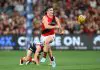 ADELAIDE, AUSTRALIA - APRIL 12: Archie Roberts of the Bombers handballs during the round five AFL match between Melbourne Demons and Essendon Bombers at Adelaide Oval, on April 12, 2025, in Adelaide, Australia. (Photo by Quinn Rooney/Getty Images via AFL Photos)