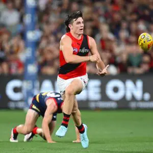 ADELAIDE, AUSTRALIA - APRIL 12: Archie Roberts of the Bombers handballs during the round five AFL match between Melbourne Demons and Essendon Bombers at Adelaide Oval, on April 12, 2025, in Adelaide, Australia. (Photo by Quinn Rooney/Getty Images via AFL Photos)