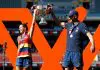 ADELAIDE, AUSTRALIA - APRIL 09: Chelsea Randall of the Crows and Matthew Clarke, Senior Coach of the Crows lift up the premiership cup during the 2022 AFLW Grand Final match between the Adelaide Crows and the Melbourne Demons at Adelaide Oval on April 09, 2022 in Adelaide, Australia. (Photo by Dylan Burns/AFL Photos via Getty Images)