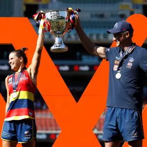 ADELAIDE, AUSTRALIA - APRIL 09: Chelsea Randall of the Crows and Matthew Clarke, Senior Coach of the Crows lift up the premiership cup during the 2022 AFLW Grand Final match between the Adelaide Crows and the Melbourne Demons at Adelaide Oval on April 09, 2022 in Adelaide, Australia. (Photo by Dylan Burns/AFL Photos via Getty Images)