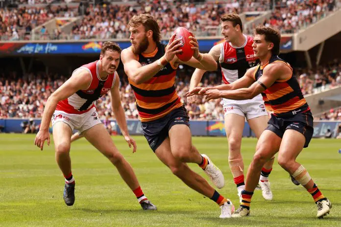 ADELAIDE, AUSTRALIA - MARCH 16: Zaine Cordy of the Saints tackles Riley Thilthorpe of the Crows during the 2025 AFL Round 01 match between the Adelaide Crows and the St Kilda Saints at Adelaide Oval on March 16, 2025 in Adelaide, Australia. (Photo by James Elsby/AFL Photos via Getty Images)