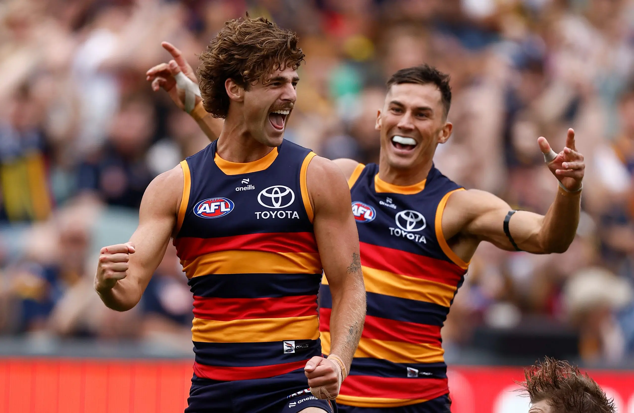 ADELAIDE, AUSTRALIA - MARCH 16: James Peatling (left) and Isaac Cumming of the Crows celebrate during the 2025 AFL Round 01 match between the Adelaide Crows and the St Kilda Saints at Adelaide Oval on March 16, 2025 in Adelaide, Australia. (Photo by Michael Willson/AFL Photos via Getty Images)