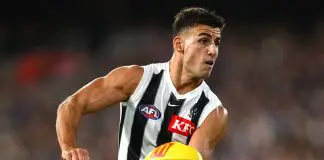 MELBOURNE, AUSTRALIA - MARCH 21: Nick Daicos of the Magpies handballs during the round two AFL match between Footscray Bulldogs (Western Bulldogs) and Collingwood Magpies at Melbourne Cricket Ground, on March 21, 2025, in Melbourne, Australia. (Photo by Quinn Rooney/Getty Images)