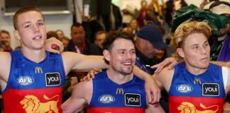 MELBOURNE, AUSTRALIA - APRIL 05: Logan Morris, Lachie Neale and Levi Ashcroft of the Lions sing the song in the rooms after winning the round four AFL match between Richmond Tigers and Brisbane Lions at Melbourne Cricket Ground, on April 05, 2025, in Melbourne, Australia. (Photo by Josh Chadwick/AFL Photos/via Getty Images)