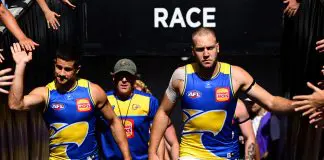 ADELAIDE, AUSTRALIA - APRIL 12: Oscar Allen of the Eagles leads his team out onto the field  during the round five AFL match between Carlton Blues and West Coast Eagles at Adelaide Oval, on April 12, 2025, in Adelaide, Australia. (Photo by Quinn Rooney/Getty Images)