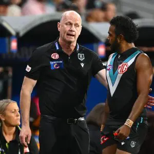 ADELAIDE, AUSTRALIA - APRIL 13: Ken Hinkley, Senior Coach of the Power speaks to Willie Rioli of the Power during the round five AFL match between Port Adelaide Power and Hawthorn Hawks at Adelaide Oval, on April 13, 2025, in Adelaide, Australia. (Photo by Quinn Rooney/Getty Images)