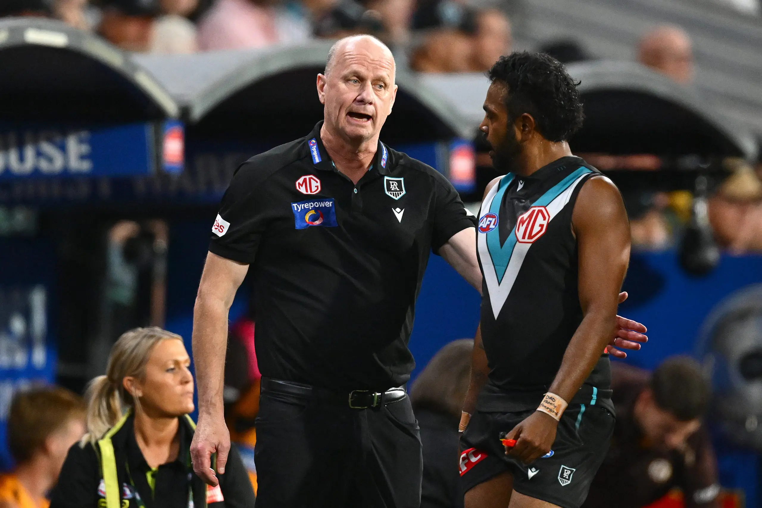 ADELAIDE, AUSTRALIA - APRIL 13: Ken Hinkley, Senior Coach of the Power speaks to Willie Rioli of the Power during the round five AFL match between Port Adelaide Power and Hawthorn Hawks at Adelaide Oval, on April 13, 2025, in Adelaide, Australia. (Photo by Quinn Rooney/Getty Images)