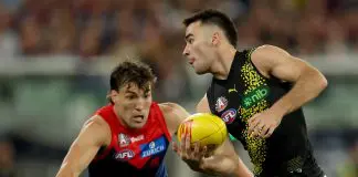 MELBOURNE, AUSTRALIA - APRIL 24: Seth Campbell of the Tigers handballs under pressure from Jack Viney of the Demons during the round seven AFL match between Melbourne Demons and Richmond Tigers at Melbourne Cricket Ground, on April 24, 2025, in Melbourne, Australia. (Photo by Robert Cianflone/Getty Images)