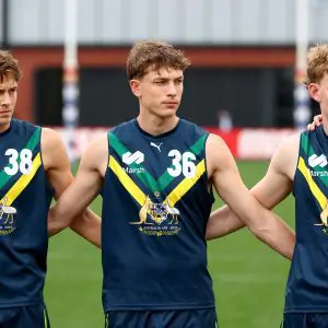 MELBOURNE, AUSTRALIA - APRIL 27: Archie Ludowyke, Liam Hetherton and Jasper Hay of the AFL National Academy huddle together for the Welcome to Country ahead of the Marsh AFL National Academy Boys match between Australia U18 and Coburg VFL at Whitten Oval on April 27, 2025 in Melbourne, Australia. (Photo by Josh Chadwick/AFL Photos/via Getty Images)