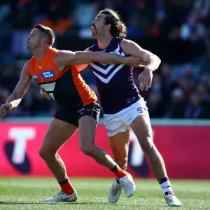 CANBERRA, AUSTRALIA - AUGUST 20: Alex Pearce of the Dockers and Jesse Hogan of the Giants compete for the ball during the round 23 AFL match between the Greater Western Sydney Giants and the Fremantle Dockers at Manuka Oval on August 20, 2022 in Canberra, Australia. (Photo by Jason McCawley/AFL Photos/via Getty Images)