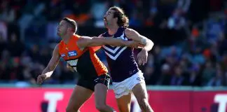CANBERRA, AUSTRALIA - AUGUST 20: Alex Pearce of the Dockers and Jesse Hogan of the Giants compete for the ball during the round 23 AFL match between the Greater Western Sydney Giants and the Fremantle Dockers at Manuka Oval on August 20, 2022 in Canberra, Australia. (Photo by Jason McCawley/AFL Photos/via Getty Images)