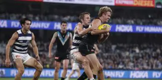 GEELONG, AUSTRALIA - MAY 10: Tom Atkins of the Cats tackles Jason Horne-Francis of the Power during the round nine AFL match between Geelong Cats and Port Adelaide Power at GMHBA Stadium, on May 10, 2024, in Geelong, Australia. (Photo by Darrian Traynor/Getty Images)