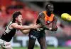 SYDNEY, AUSTRALIA - JUNE 16: Leek Aleer of the Giants  handballs to a team mate during the round 14 AFL match between Greater Western Sydney Giants and Port Adelaide Power at ENGIE Stadium, on June 16, 2024, in Sydney, Australia. (Photo by Brendon Thorne/AFL Photos/via Getty Images)