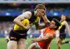 MELBOURNE, AUSTRALIA - JULY 14: Tom Brown of the Tigers is tackled by Tom Green of the Giants during the 2024 AFL Round 18 match between the Richmond Tigers and the GWS GIANTS at Melbourne Cricket Ground on July 14, 2024 in Melbourne, Australia. (Photo by Michael Willson/AFL Photos via Getty Images)