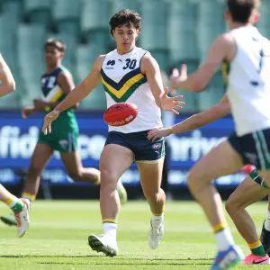 MELBOURNE, AUSTRALIA - SEPTEMBER 28: Tairon Ah-Mu of Team Sloane kicks the ball during the Marsh AFL National Futures Boys match between Team Heppell and Team Sloane at Melbourne Cricket Ground, on September 28, 2024, in Melbourne, Australia. (Photo by Daniel Pockett/AFL Photos/via Getty Images)