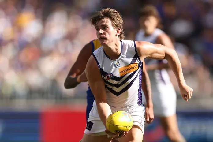 PERTH, AUSTRALIA - MARCH 30: Caleb Serong of the Dockers looks to handball during the round three AFL match between West Coast Eagles and Fremantle Dockers at Optus Stadium, on March 30, 2025, in Perth, Australia. (Photo by Paul Kane/Getty Images)