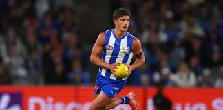 MELBOURNE, AUSTRALIA - APRIL 05: Harry Sheezel of the Kangaroos takes possession of the ball during the round four AFL match between North Melbourne Kangaroos and Sydney Swans at Marvel Stadium, on April 05, 2025, in Melbourne, Australia. (Photo by Morgan Hancock/Getty Images)