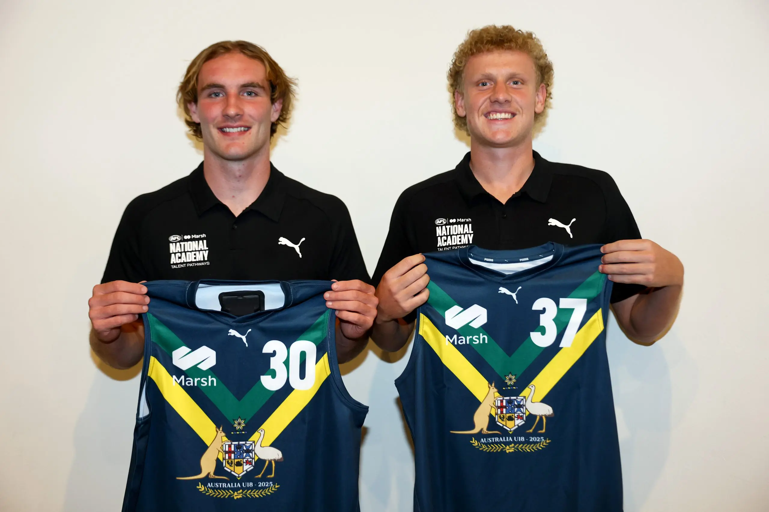 MELBOURNE, AUSTRALIA - APRIL 12: Dyson Sharp and Matthew LeRay of the AFL National Academy pose after being presented with their jumpers during the Marsh AFL National Academy Boys Jumper Presentation at Mercure Albert Park on April 12, 2025 in Melbourne, Australia. (Photo by Josh Chadwick/AFL Photos/via Getty Images)