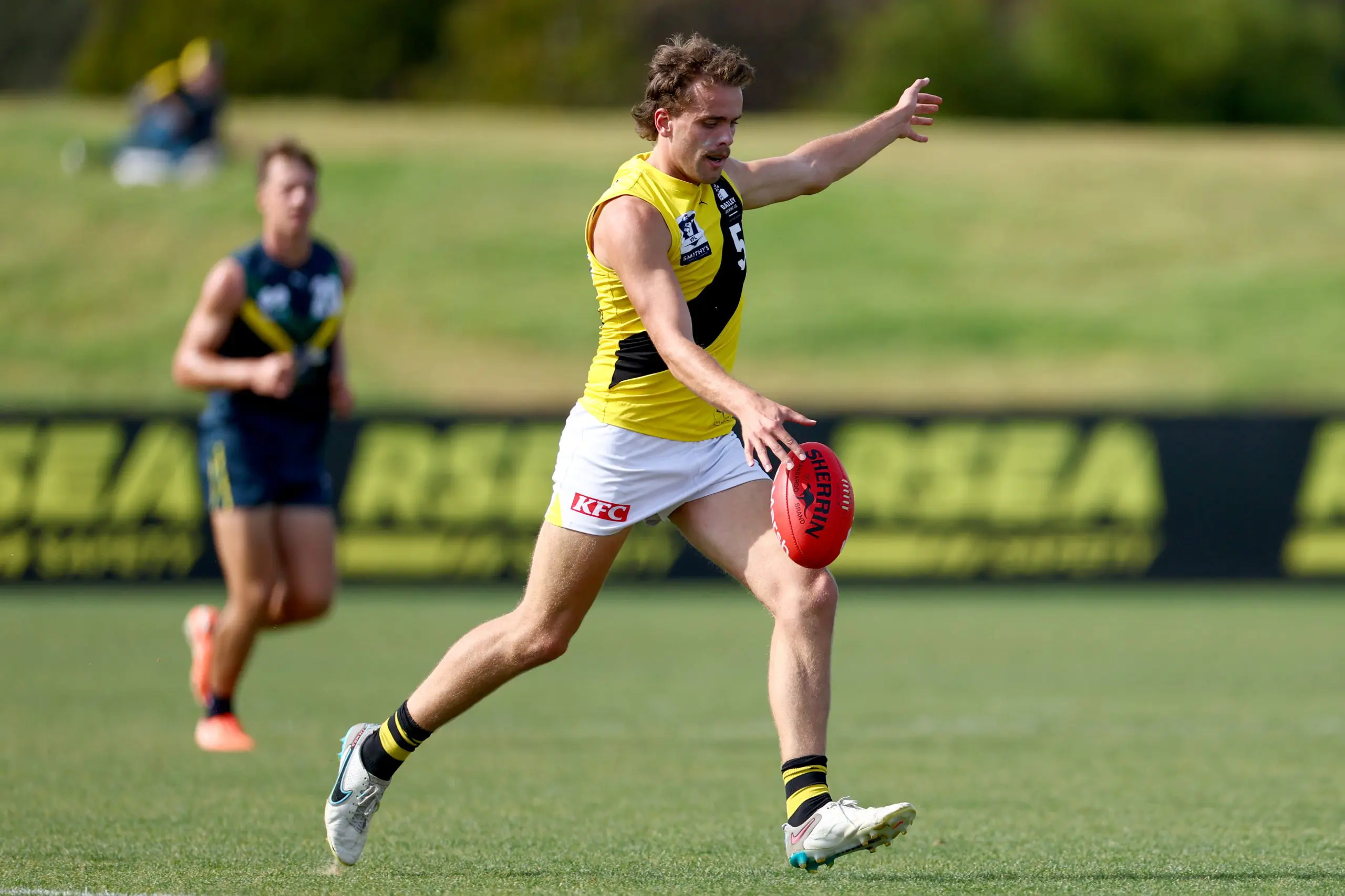 MELBOURNE, AUSTRALIA - APRIL 13: Tom McCarthy of the Tigers kicks during the Marsh AFL National Academy Boys match between Australia U18 and Richmond VFL at RSEA Park on April 13, 2025 in Melbourne, Australia. (Photo by Josh Chadwick/AFL Photos/via Getty Images)