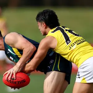 MELBOURNE, AUSTRALIA - APRIL 13: Thomas Burton of the AFL National Academy is tackled during the Marsh AFL National Academy Boys match between Australia U18 and Richmond VFL at RSEA Park on April 13, 2025 in Melbourne, Australia. (Photo by Josh Chadwick/AFL Photos/via Getty Images)