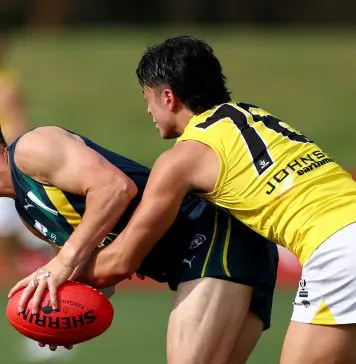 MELBOURNE, AUSTRALIA - APRIL 13: Thomas Burton of the AFL National Academy is tackled during the Marsh AFL National Academy Boys match between Australia U18 and Richmond VFL at RSEA Park on April 13, 2025 in Melbourne, Australia. (Photo by Josh Chadwick/AFL Photos/via Getty Images)