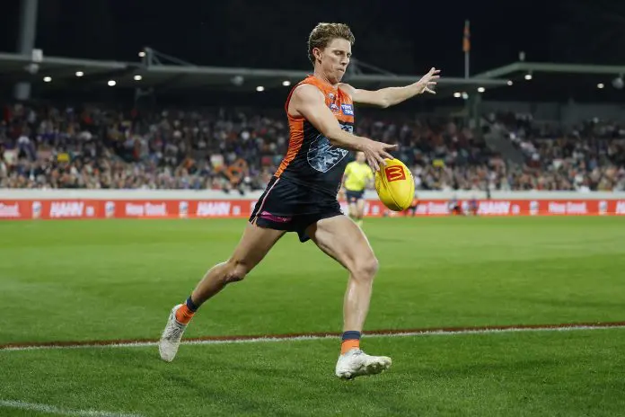 CANBERRA, AUSTRALIA - APRIL 26: Lachie Whitfield of the Giants kicks the ball during the round seven AFL match between GWS Giants and Western Bulldogs at Manuka Oval, on April 26, 2025, in Canberra, Australia. (Photo by Darrian Traynor/Getty Images)