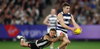 MELBOURNE, AUSTRALIA - MAY 03: Shaun Mannagh of the Cats is tackled by Bobby Hill of the Magpies during the 2025 AFL Round 08 match between the Collingwood Magpies and the Geelong Cats at the Melbourne Cricket Ground on May 3, 2025 in Melbourne, Australia. (Photo by Michael Willson/AFL Photos via Getty Images)