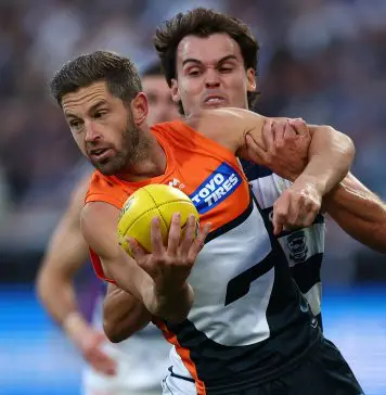 GEELONG, AUSTRALIA - MAY 11: Callan Ward of the Giants is tackled during the round nine AFL match between Geelong Cats and GWS Giants at GMHBA Stadium on May 11, 2025 in Geelong, Australia. (Photo by Graham Denholm/AFL Photos/Getty Images)