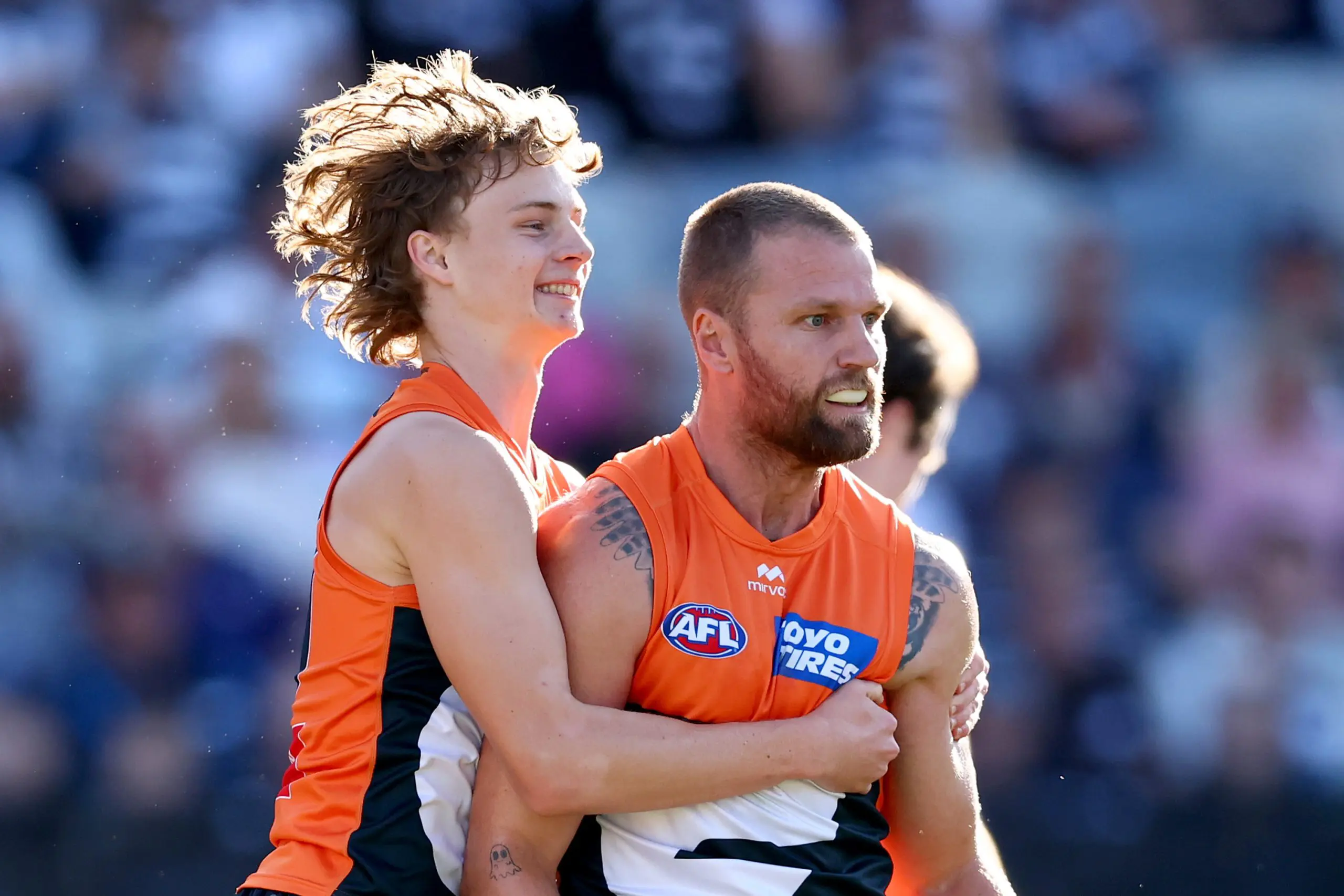 GEELONG, AUSTRALIA - MAY 11: Jake Stringer of the Giants is congratulated by Cody Angove after kicking a goal during the round nine AFL match between Geelong Cats and GWS Giants at GMHBA Stadium, on May 11, 2025, in Geelong, Australia. (Photo by Josh Chadwick/Getty Images)