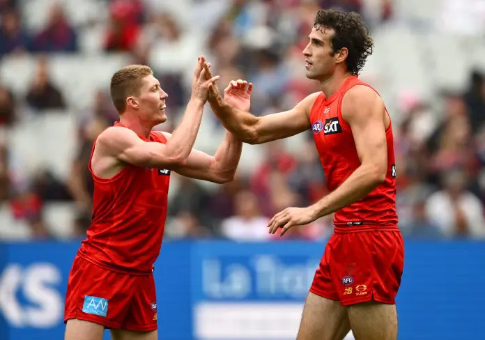 MELBOURNE, AUSTRALIA - MARCH 29: Ben King of the Suns is congratulated by Matt Rowell of the Suns after kicking a goal during the round three AFL match between Melbourne Demons and Gold Coast Suns at Melbourne Cricket Ground, on March 29, 2025, in Melbourne, Australia. (Photo by Quinn Rooney/Getty Images)