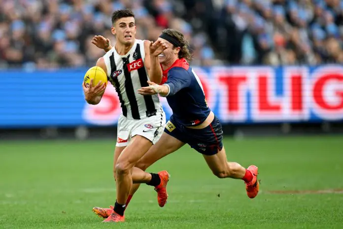 MELBOURNE, AUSTRALIA - JUNE 09: Nick Daicos of the Magpies is tackled by Ed Langdon of the Demons during the round 13 AFL match between Melbourne Demons and Collingwood Magpies at Melbourne Cricket Ground, on June 09, 2025, in Melbourne, Australia. (Photo by Quinn Rooney/Getty Images)