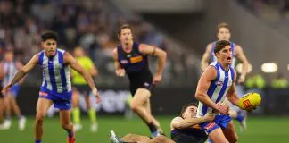 PERTH, AUSTRALIA - JUNE 14: Jordan Clark of the Dockers tackles Harry Sheezel of the Kangaroos during the round 14 AFL match between North Melbourne Kangaroos and Fremantle Dockers at Optus Stadium, on June 14, 2025, in Perth, Australia. (Photo by Paul Kane/Getty Images)